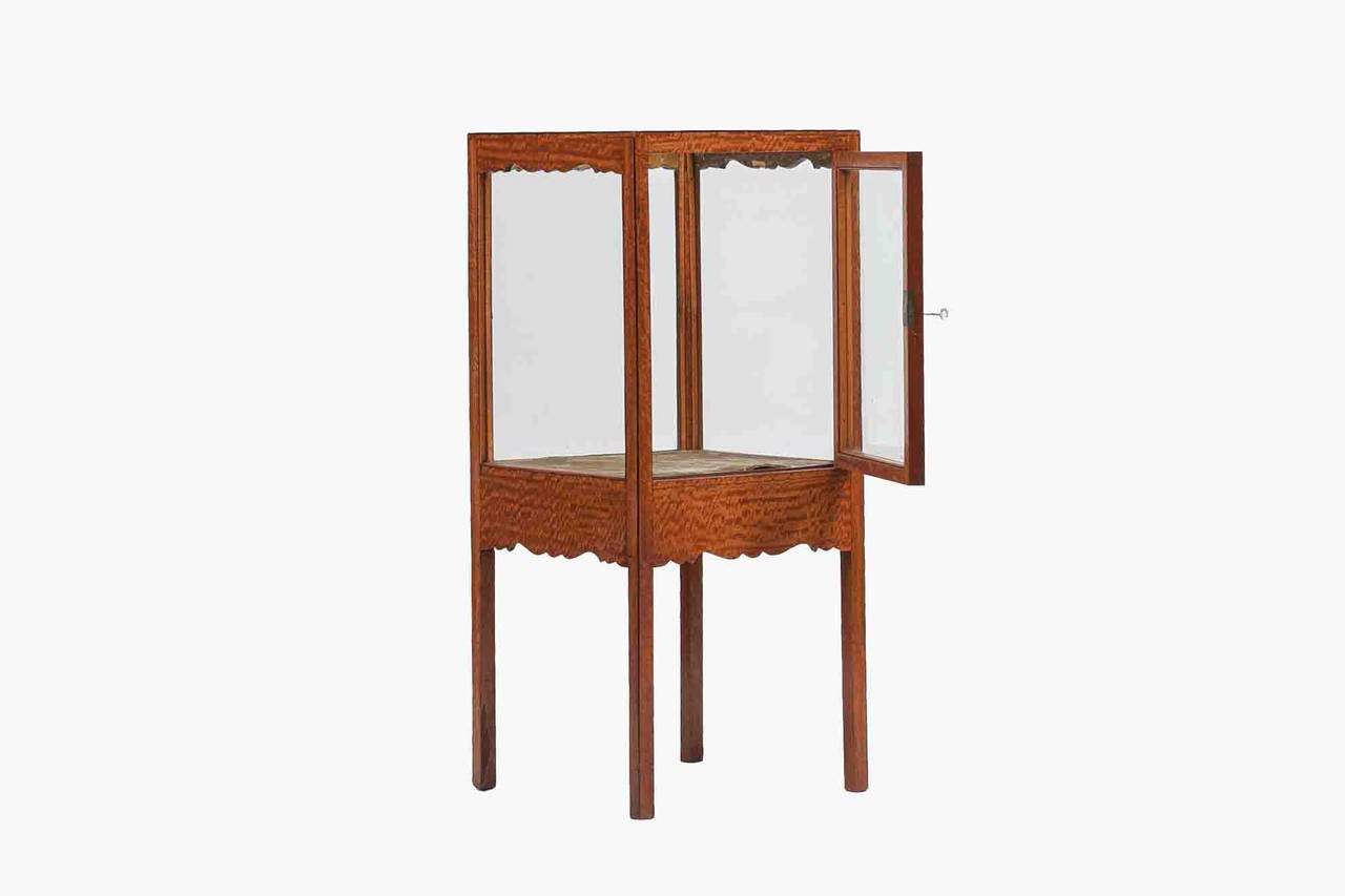 19th century satinwood display case, the glazed top and sides raised over shaped and carved apron terminating on marlborough leg.