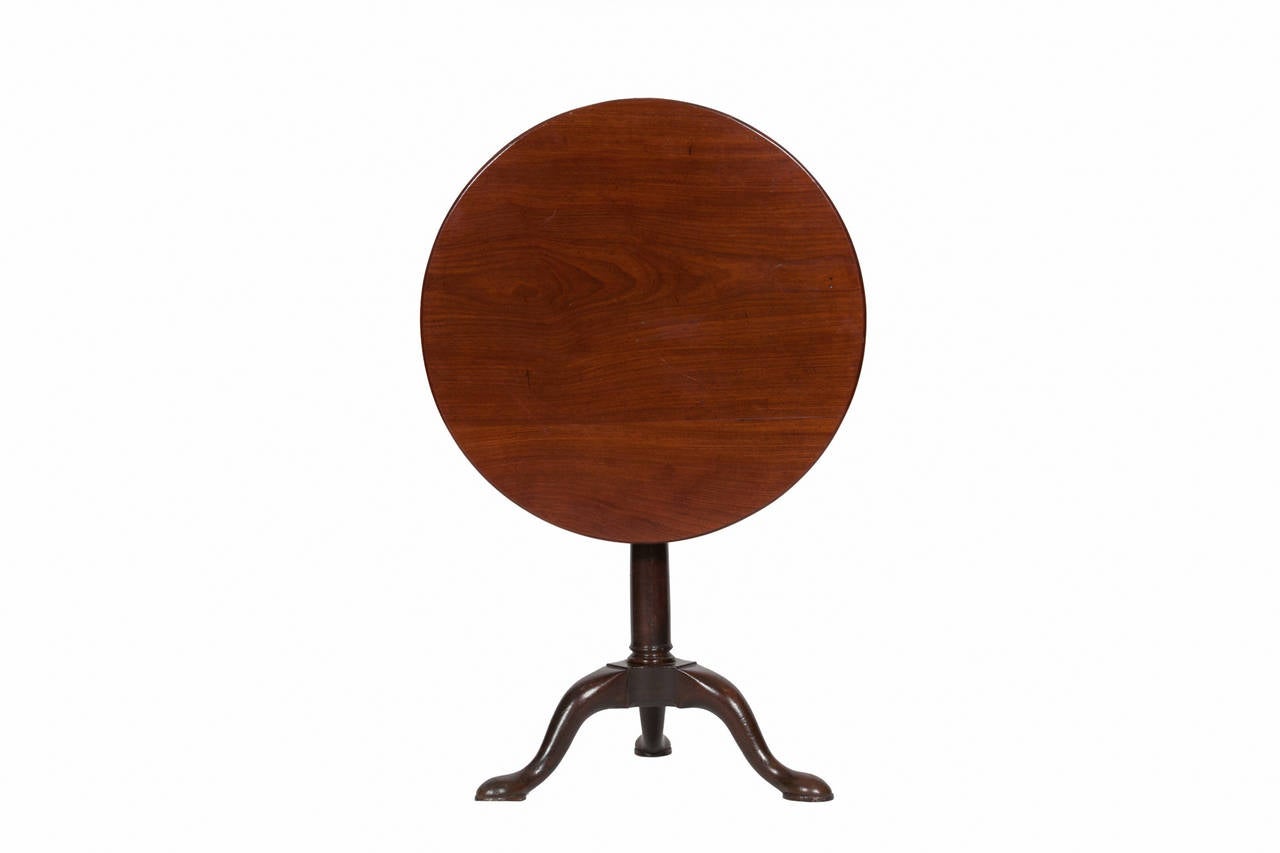 18th Century George III mahogany occasional tip-up table.  The circular top on bird cage pod with three out splayed legs.
