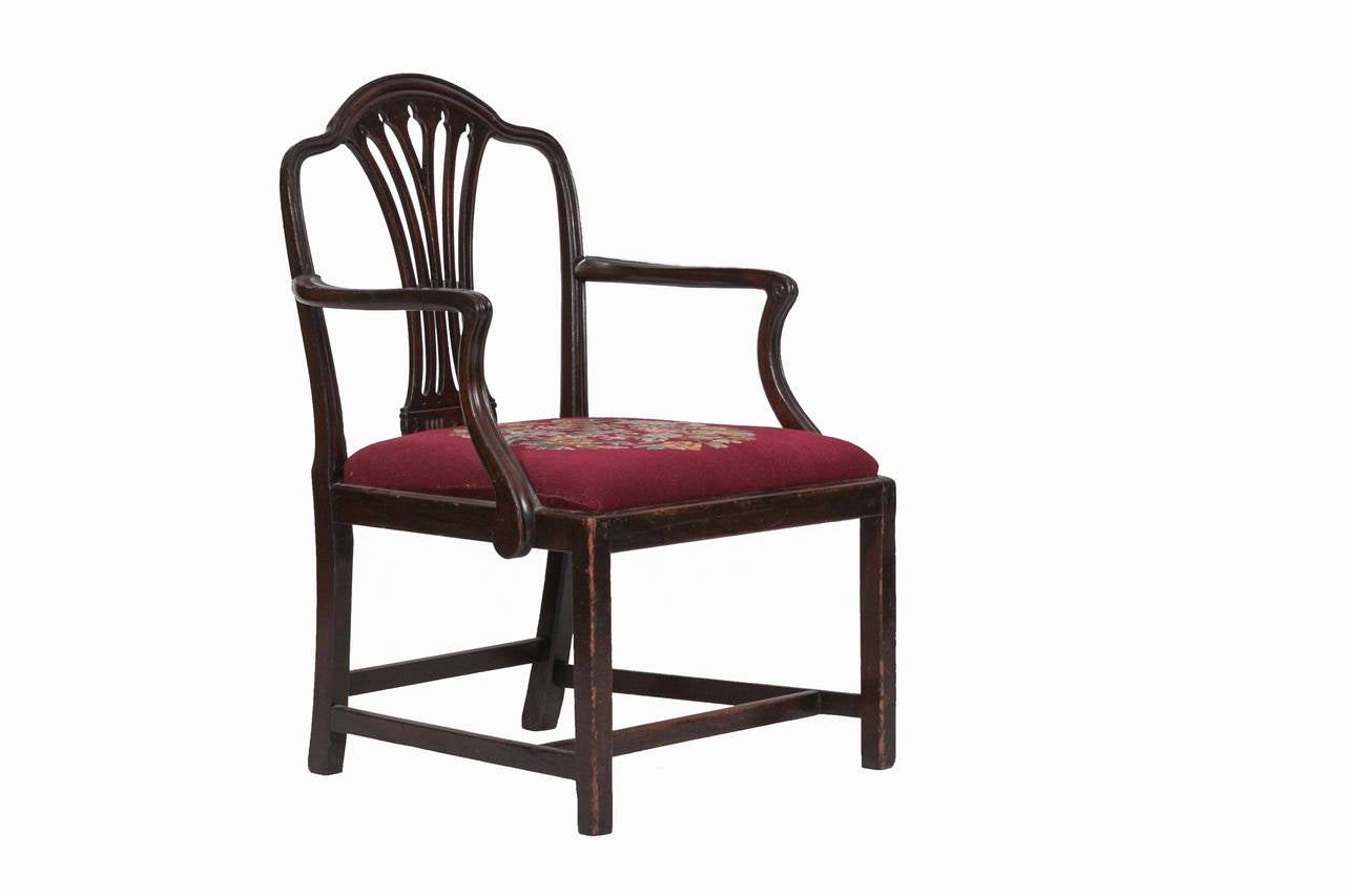 18th century mahogany Chippendale style carver. The back and arms fluted and centred by pierced wheat leaf shape splat, raised on square section legs