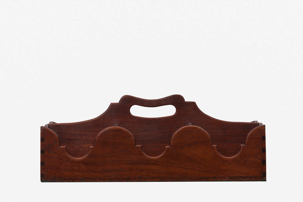 19th Century English mahogany bottle holder in the Georgian style with six compartment each with shaped solid side and central handle.