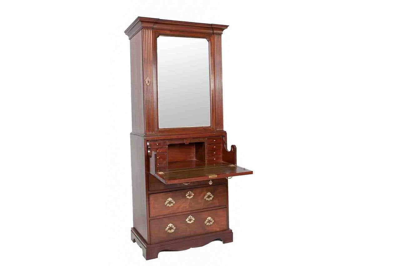 Early 19th Century George III mahogany secretaire bookcase. Comprising of a single mirrored door enclosing an interior with two adjustable shelves below a molded cornice design secretaire drawer. The interior has drawers and pigeonholes, the writing