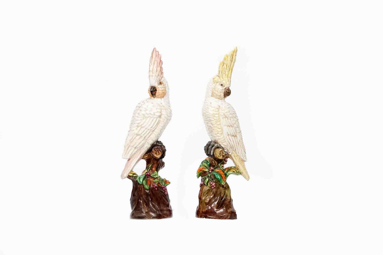 19th century large ceramic hand painted polychrome animalier sculpture of a pair of Cockatoos surmounted on tree branch with trailing foliate and flower head motif.