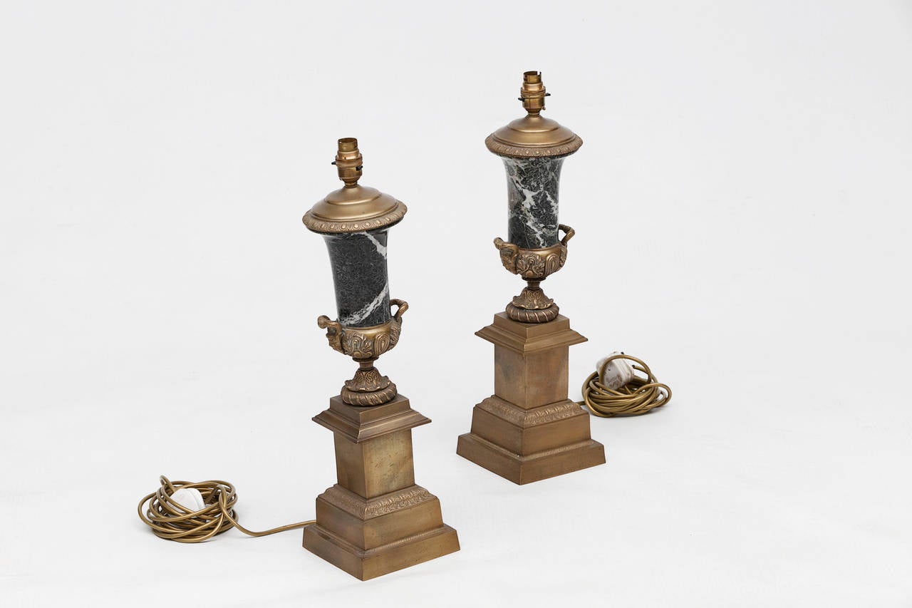 19th century pair of brass and marble table lamps. In the form of a classical urns raised on brass plinths.