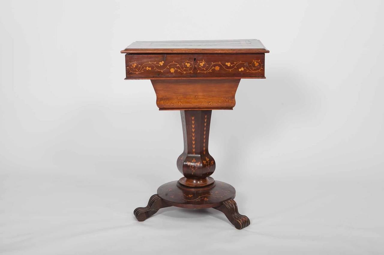 19th c. Killarney-ware arbutus marquetry work table. The rectangular top ornately inlaid with a crowned harp, shamrock and fern leaves, roundels depicting ruins and a cottage. The lid lifts to reveal a removable fitted and sectioned sewing tray,