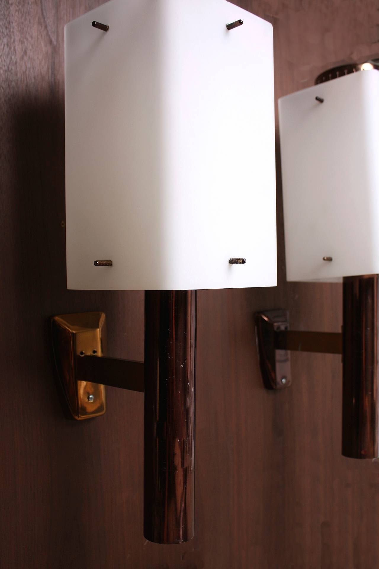 Beautiful Stilnovo sconces designed in Italy from the 1950s. Opaline glass shades with a burnt brown enameled base with brass details.