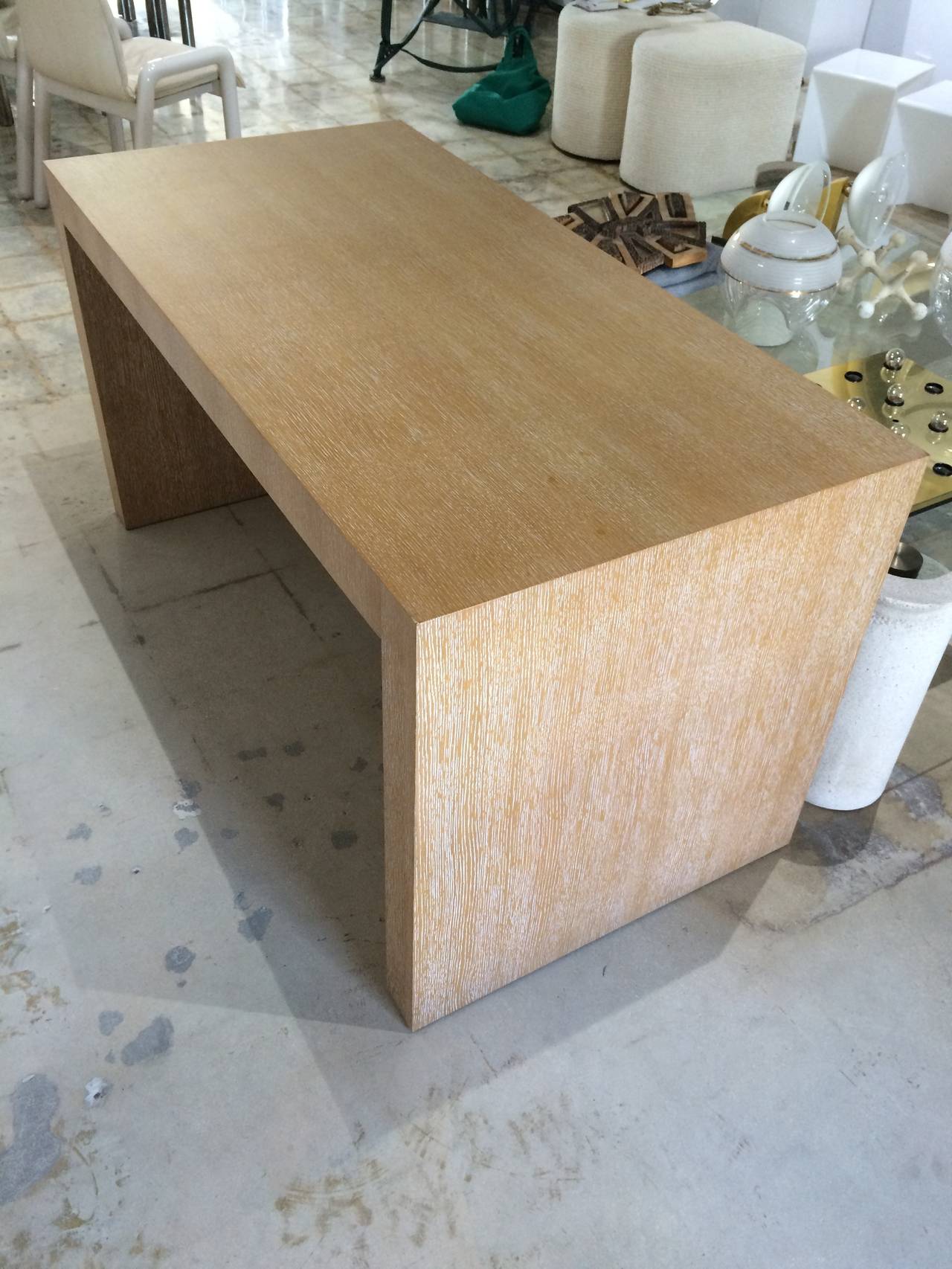 Cerused white oak Parsons style desk in the manner of Jean Michel Frank designed by Giorgio Armani for Armani Casa.

Desk has two seamless mitered drawers and is finished in cerused oak inside as well.

Internal dimensions:
48.75