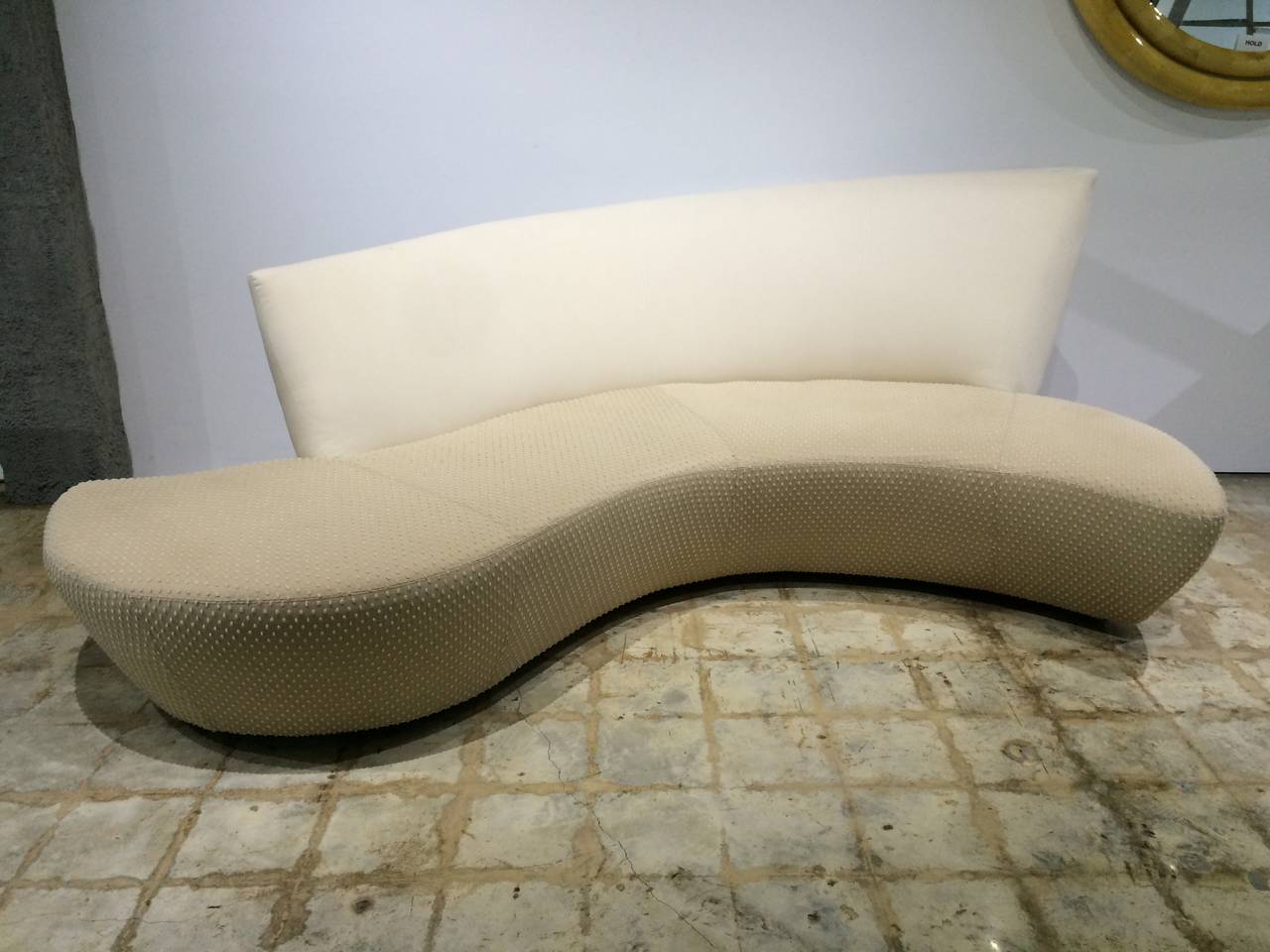 Sculptural sofa in two-tone fabric combination of a beige and ivory dotted-swiss seat and ivory ultra suede back, designed by Vladimir Kagan who was inspired by Frank Gehry's Guggenheim Museum in Bilbao, Spain.

Sofa is upholstered in midnight blue