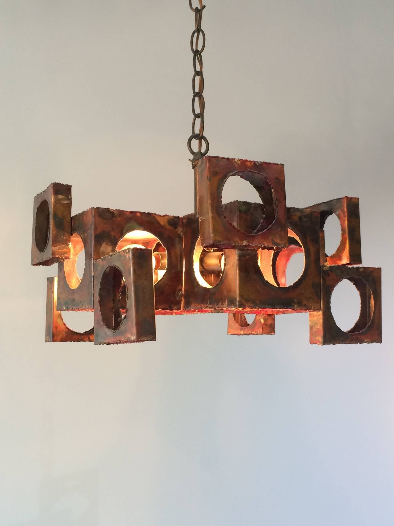 Three Brutalist chandeliers with attributes of cubist and geometric design by Tom Greene for the Feldman Lighting Co.

Price is per Item.