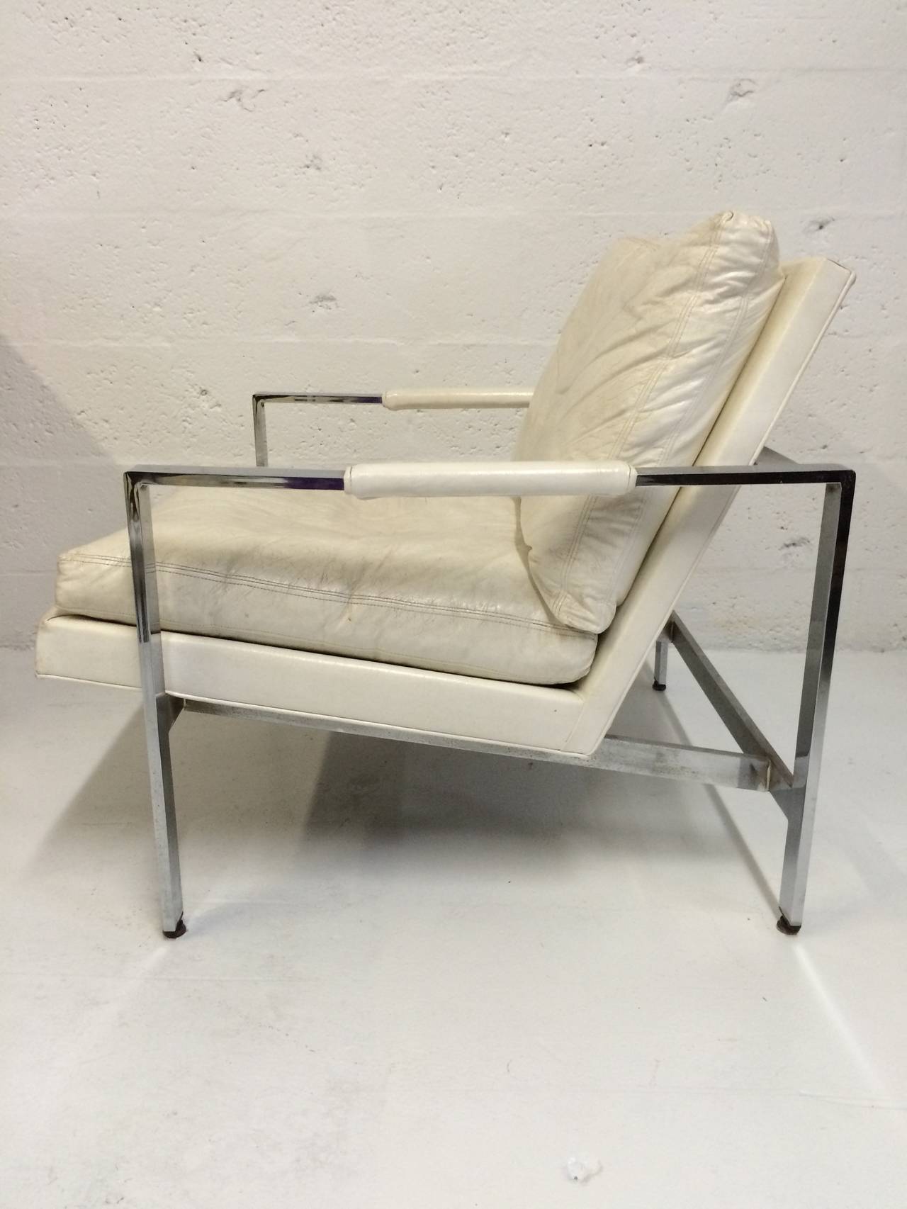 Pair of original white naugahyde and chrome club chairs designed by Milo Baughman for Thayer Coggin.

Reupholstery reccommended.