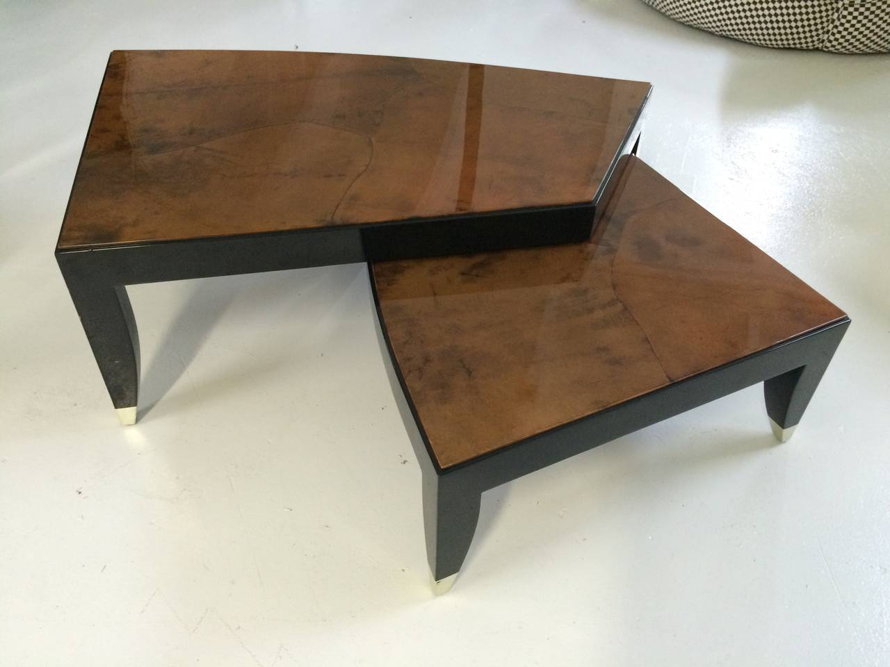 Expanding 2-part lacquered goatskin and black lacquered leg Bristol coffee table with silver leafed feet designed by Karl Springer.

Additional Measurements:
44