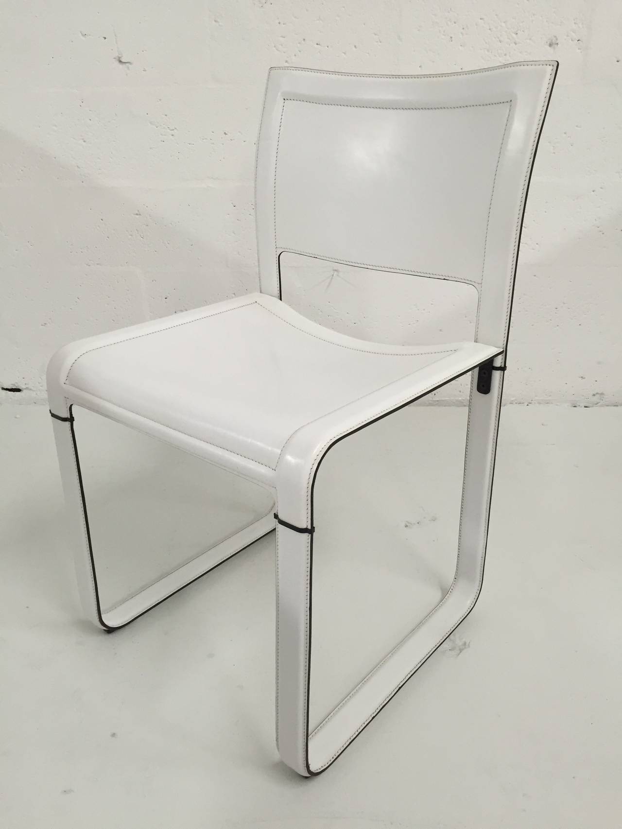 Set of six white leather dining chairs designed by Matteo Grassi.
