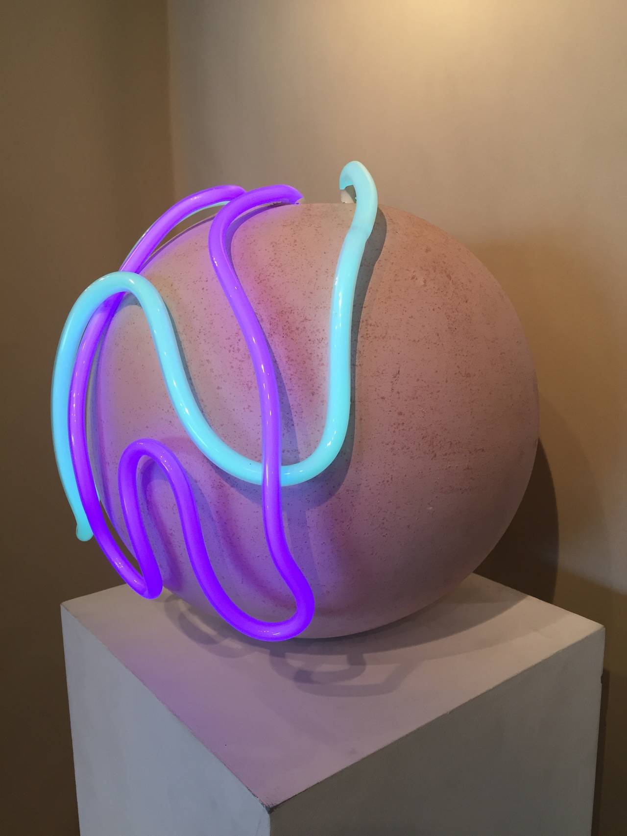 Turquoise and purple neon flow from a pink sand textured ceramic vessel. Artist Signed, 1990.