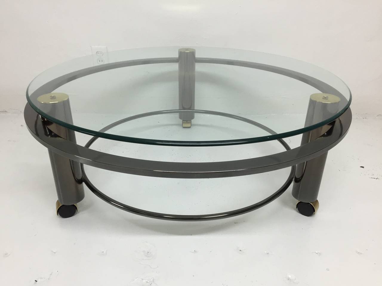 Gunmetal and brass circular coffee table on casters by DIA, Design Institute of America.