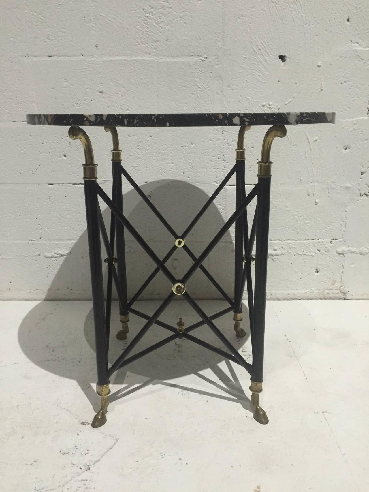 Marble top occasional table with patinated brass and black enamel base by Maison Jansen.