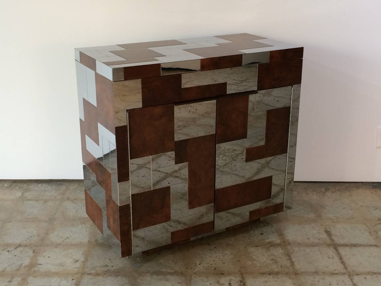 Rare Paul Evans Studio burl wood and chrome flip-top cityscape bar cabinet on castors and finished on all sides.