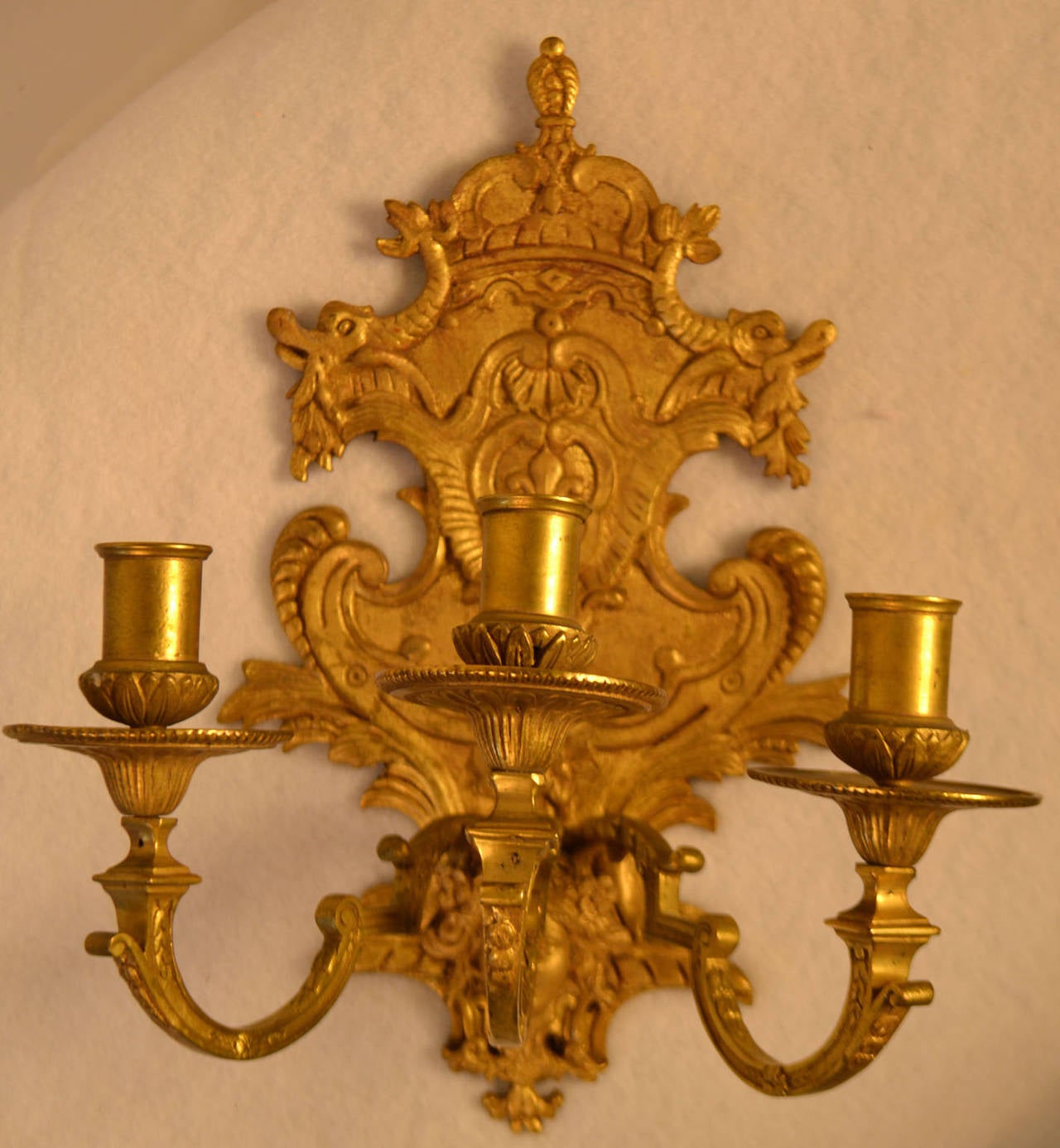 Pair of gilded Louis XVI style wall sconces (three lights) circa 1860. Not wired.