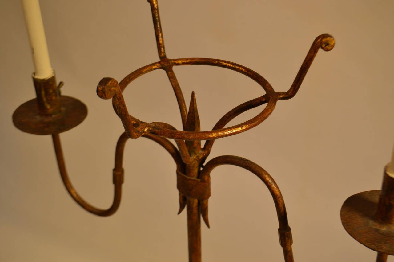 Turn-of-the-century (circa 1900) wrought iron double-light floor lamp with rawhide shades.