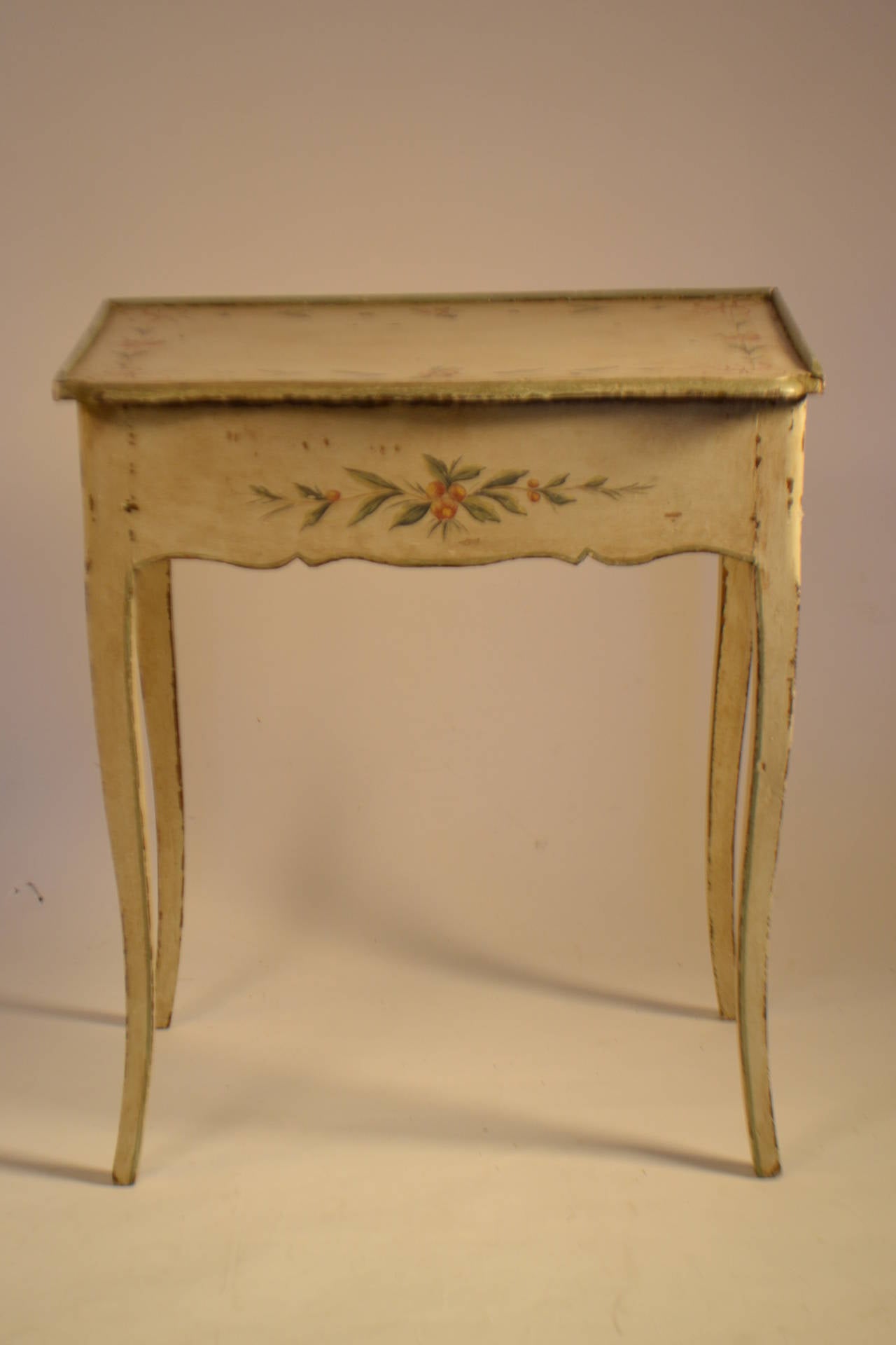 Exquisite Louis XV Period Dressing table with creme peinte, and an olive green border. The flip top opens to a flower motif padded interior which holds brass and glass perfume bottles and jars.  There are several compartments for all kinds of