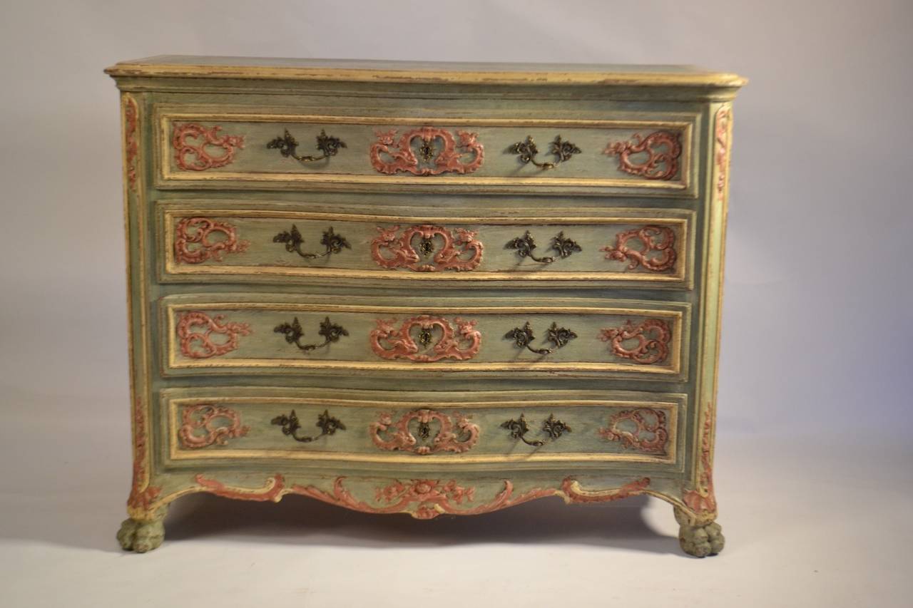 Lovely  Louis XV period commode in red and green with beautiful and detailed carving around the key plates, resting on a c scroll apron and claw feet.