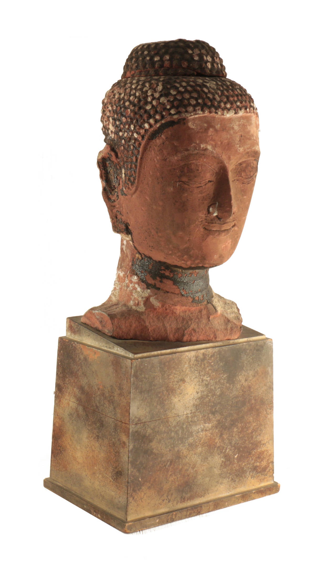 Stone Buddha head, 16th century Ayutthaya, Thailand. Red sandstone. Classic form with blissful expression, undulating eye-lids, and heart-shaped hairline with tight curls.