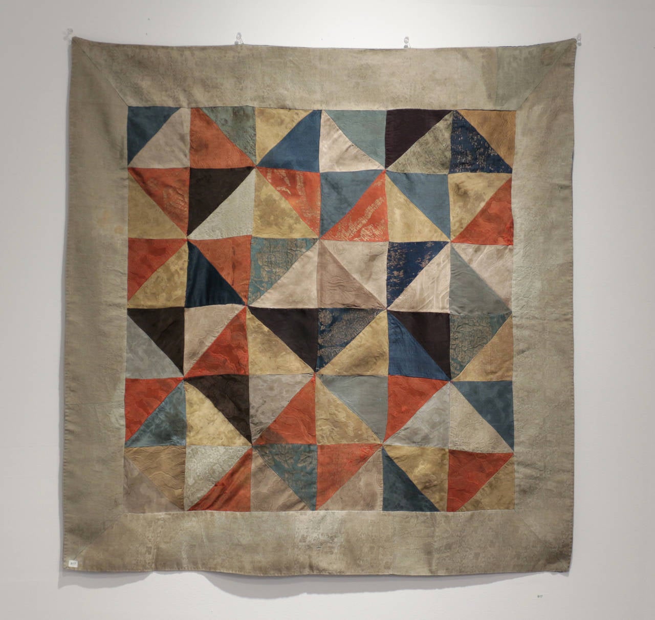Silk Buddhist offering cloth, 18th century Tibet.
This primordial applique pattern of rainbow colored silks is traditional to Buddhist offering ceremonies since the time of the Buddha himself, 2500 years ago. The pattern not only has an op art like