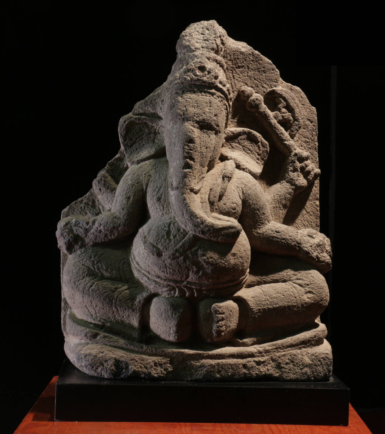 11th Century Ganesh from Java is carved from Volcanic Stone. 

The lotus petal on the rear of the sculpture indicates that this piece was once part of a larger series of sculptures arranged to form a full lotus flower possibly at the base of a