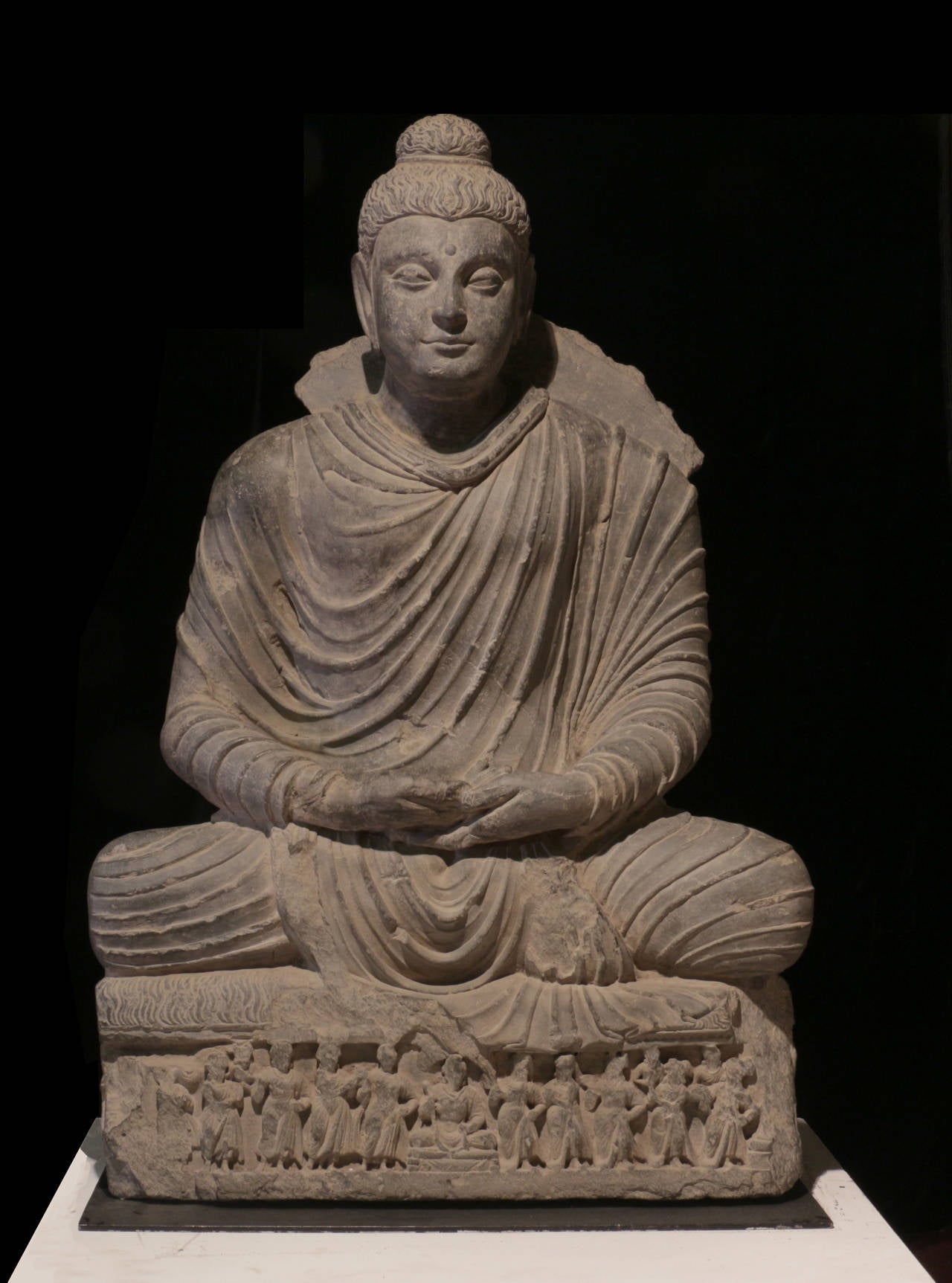 This stunning example of Gandharan stone sculpture is more than 1700 years old and in beautiful condition relative to its antiquity. This image of the seated Buddha in the mudra of meditation and absolute calm is more than 3 feet tall. 

Gandharan