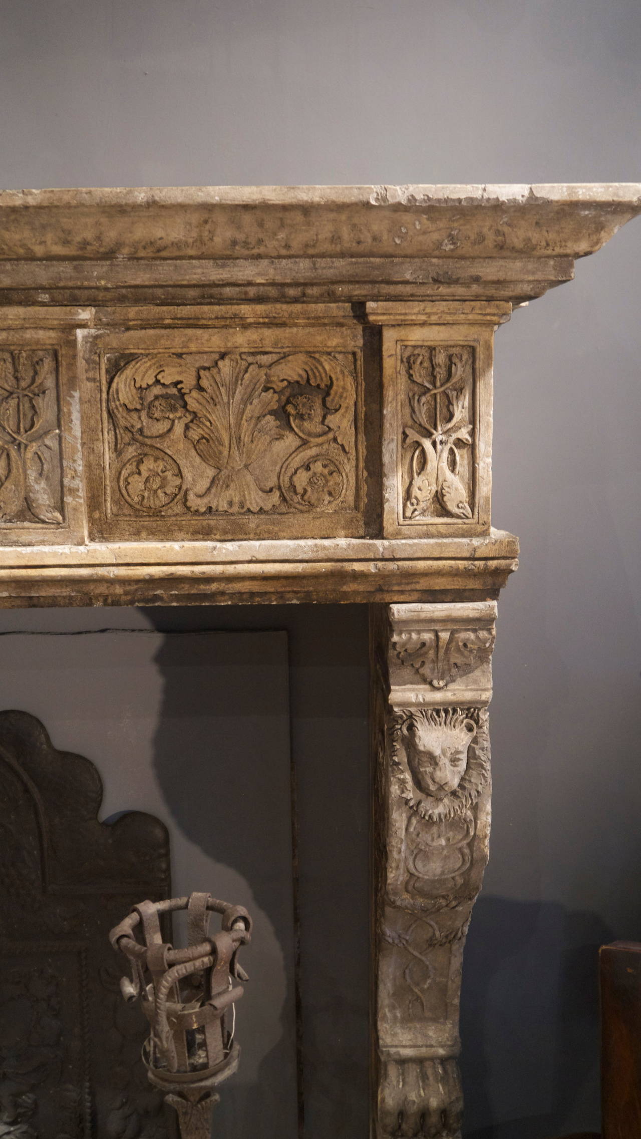 A huge 19th century Italian stone surround with lion heads on the jambs and lion paw foot blocks.