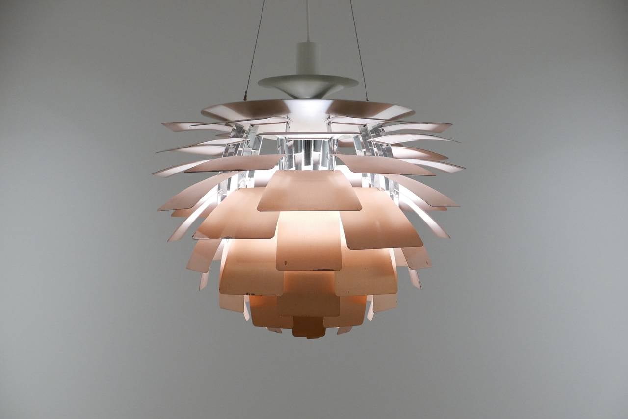 A multilayered shade shaped like the Artichoke.  The copper leaf-like elements compose a dramatic and atmospheric form.