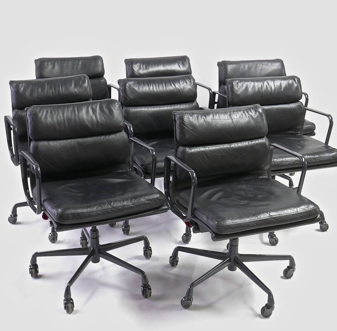 The Soft Pad chair is a design icon. This comfortable and functional set features black leather upholstery with graphite powder coated aluminum frames. The seat is height and tilt adjustable. Originally designed in 1969 this matching group is from