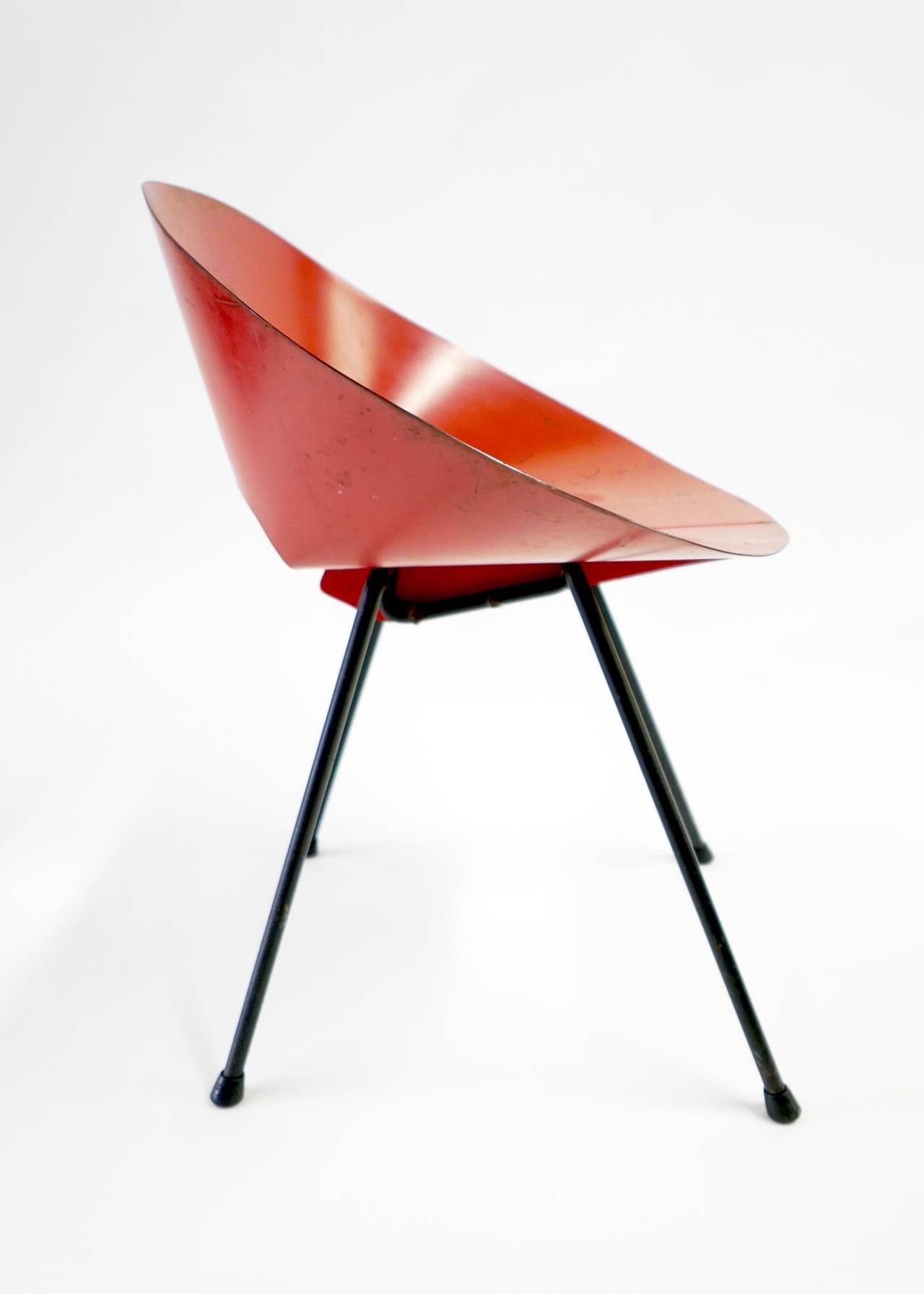 This design won first place in the museum of Modern Arts Low Cost Furniture Competition in 1948. A simple thin piece of steel creates the backrest and seat. Offered in original condition with a beautiful patina.