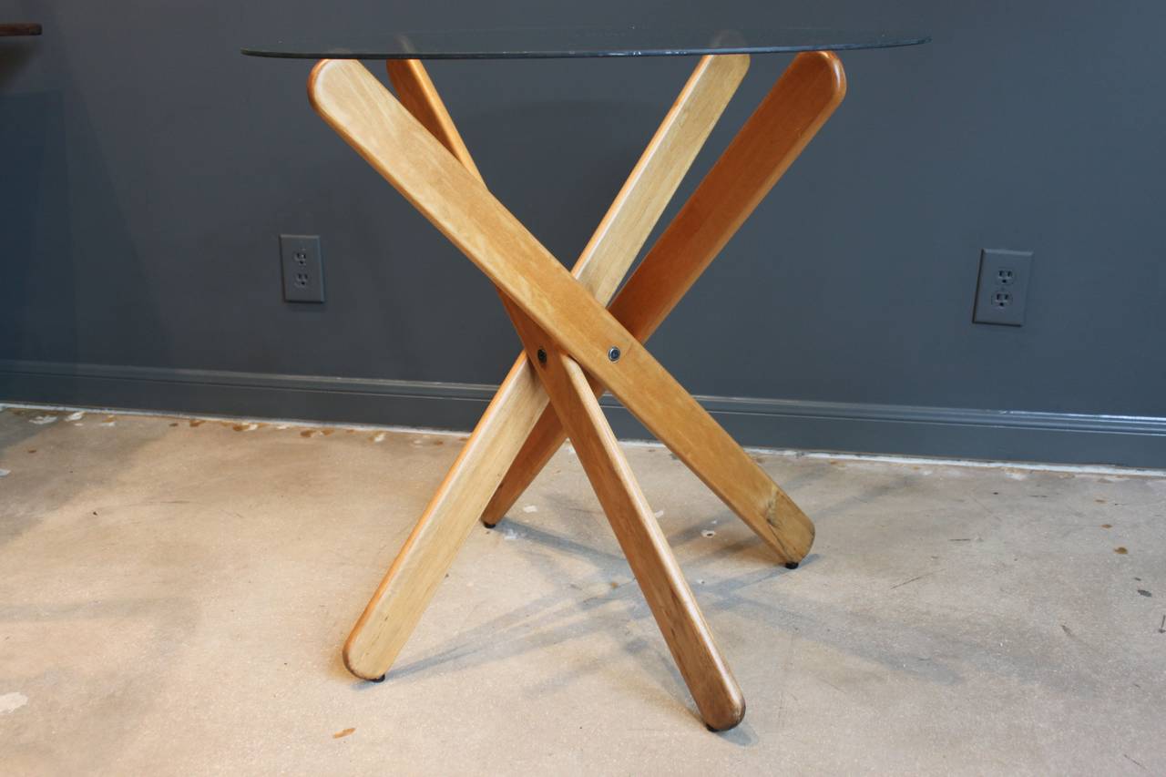 This 1970s table by Dan Droz is solid wood with a vintage glass top.

The table can be taken apart and also has original feet. 

It is marked 