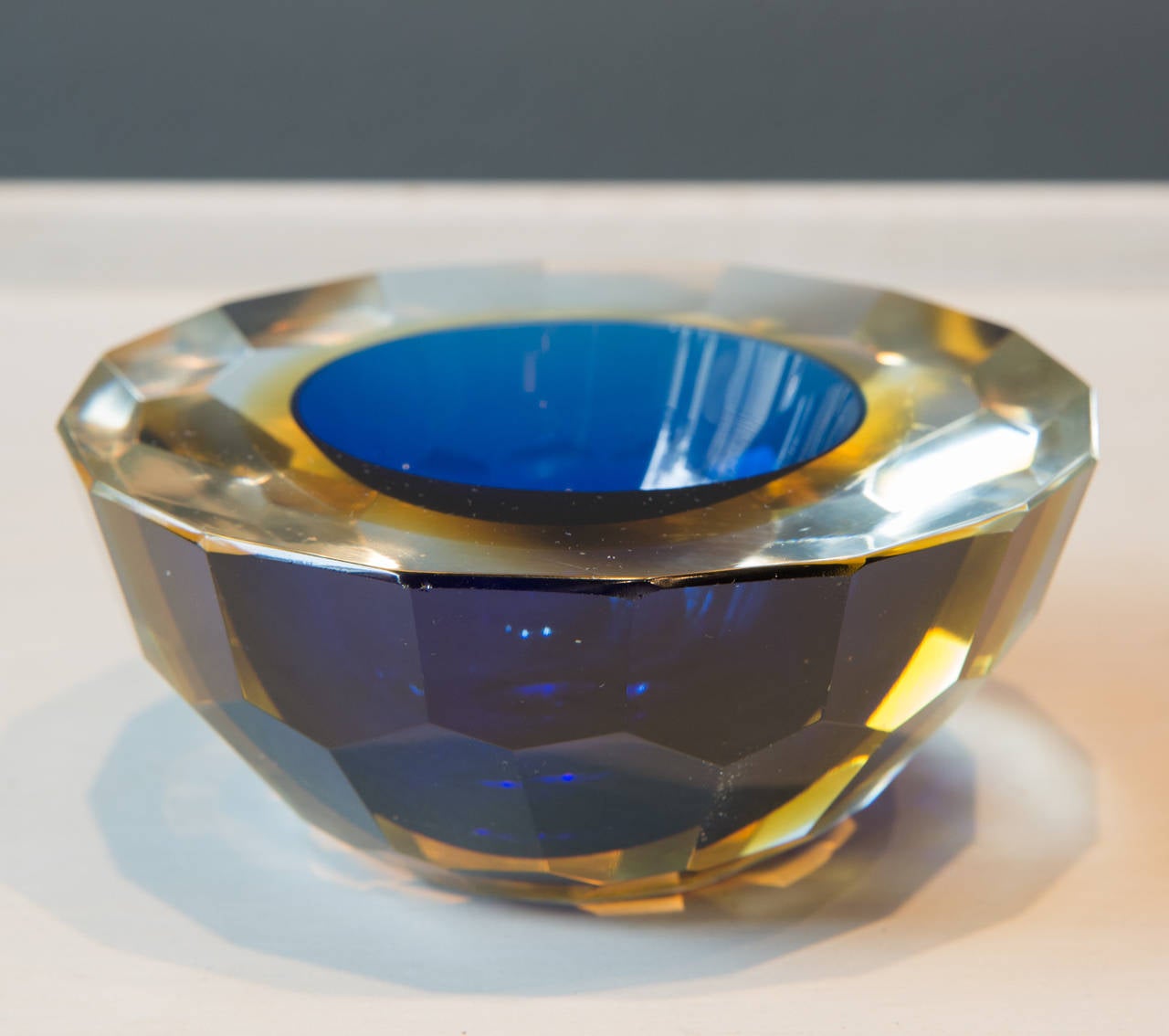 Lovely faceted very heavy crystal bowl with sapphire blue color, 20th century. Also available is a companion bowl with an emerald green color interior.