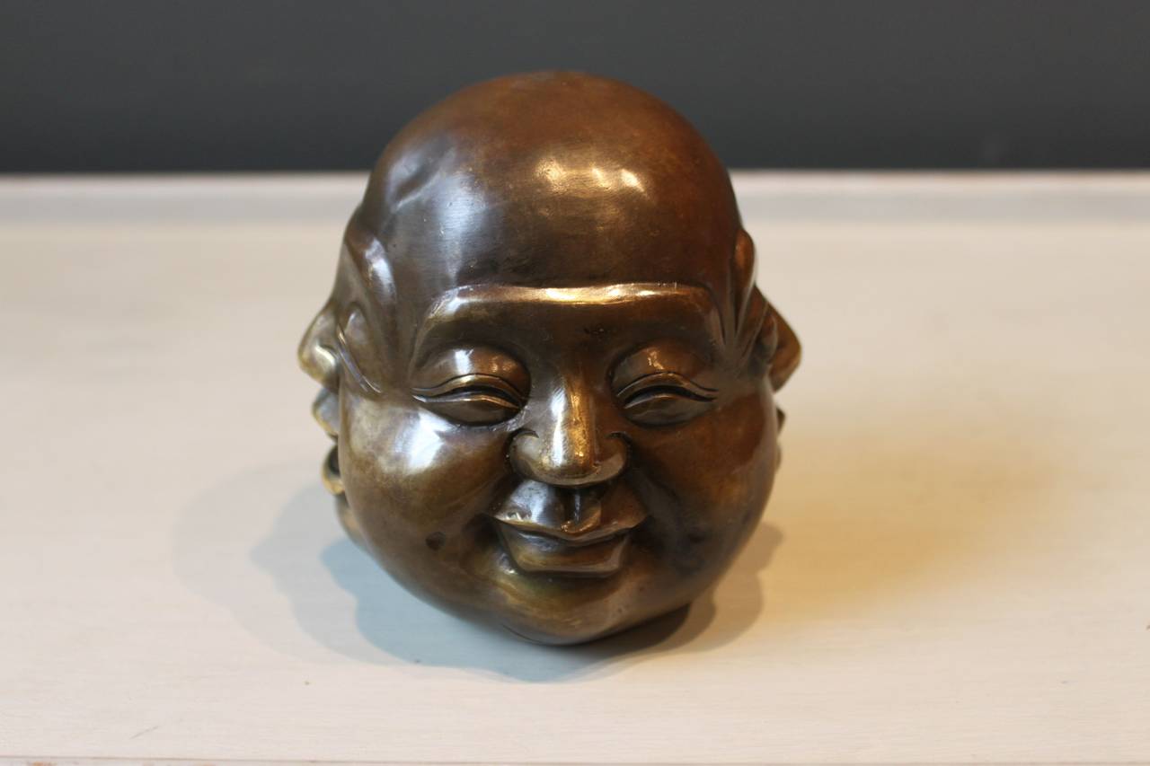 Wonderful and playful brass sculpture of a Buddha head showing four different faces (happy, laughing, angry and sad), Japan, 19th Century.