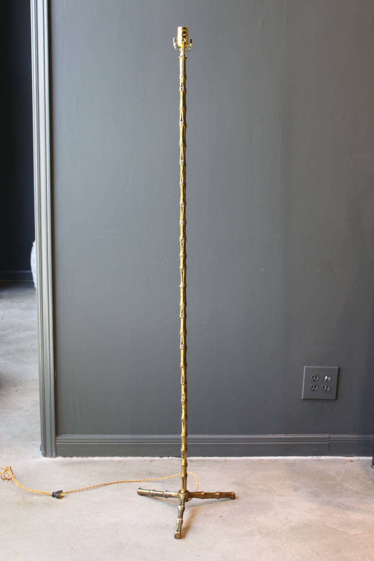 Maison Baguès faux bamboo brass tripod floor lamp, France, mid-20th century. This floor lamp has been newly wired and is 61