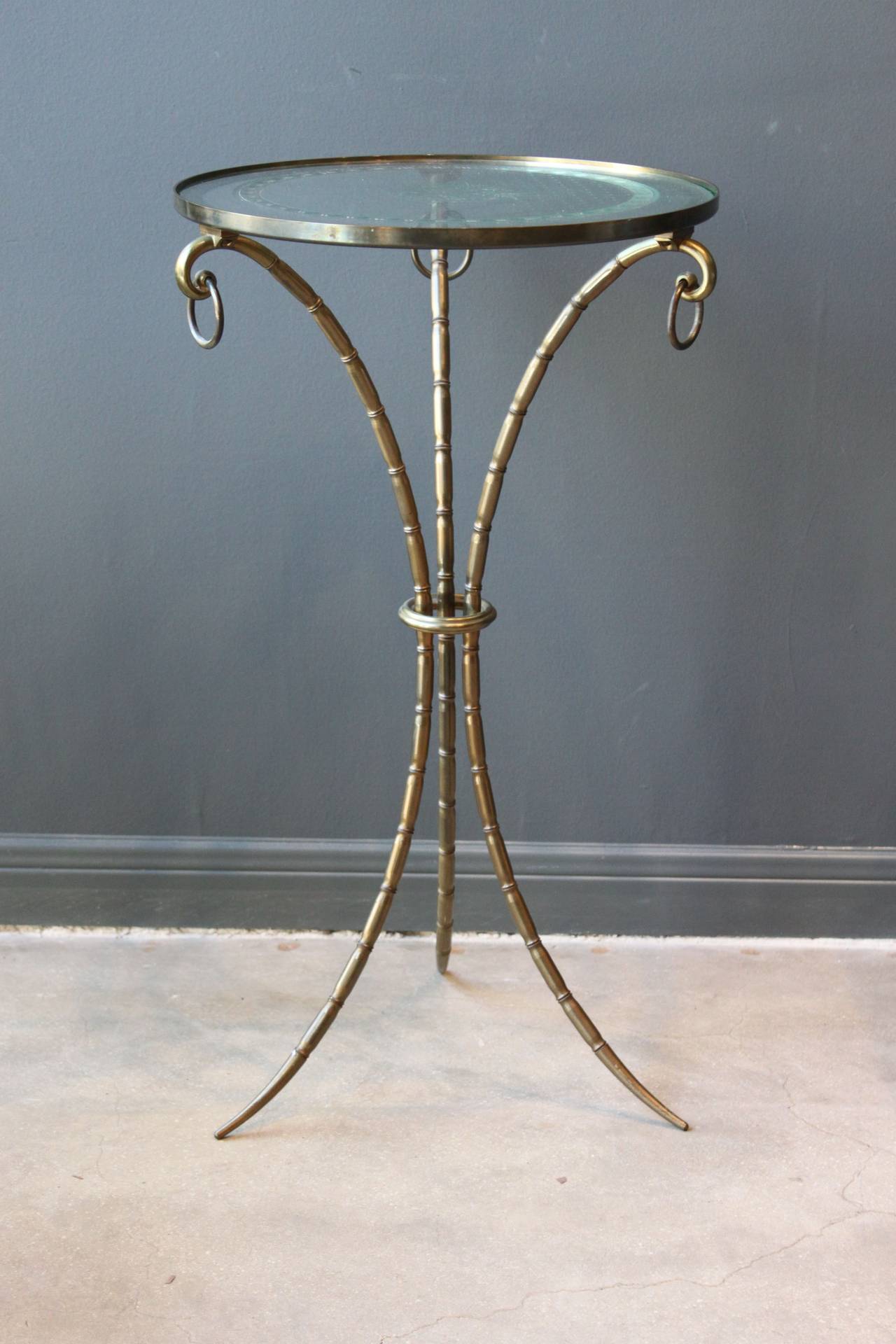 A wonderful French faux bamboo brass gueridon with an etched glass top, circa 1940s. The etched glass top has a lovely floral design.