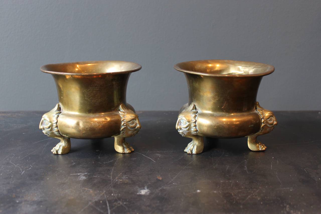 Lovely pair of brass footed cachepot with lion detailing and paw feet.