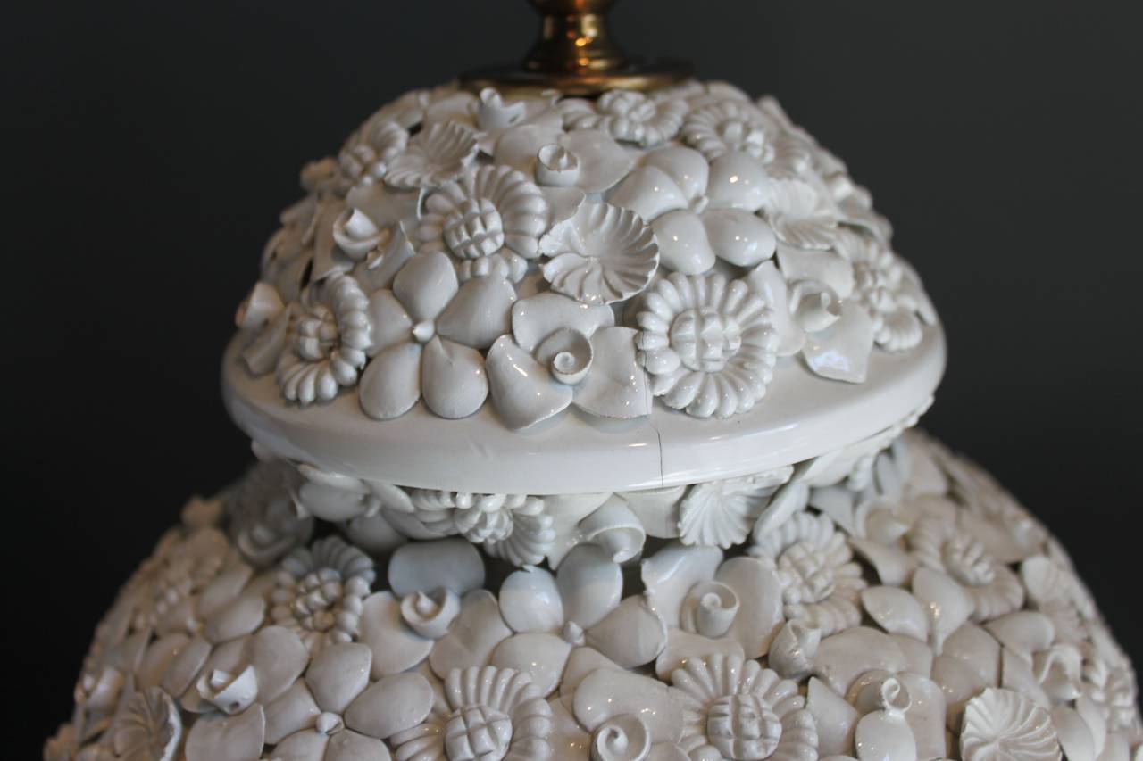 Lovely pair of white Italian lamps on a wooden base with intricately formed white porcelain flowers applied throughout. The lamps have slight variation as they are handmade but are a pair.

29 1/2