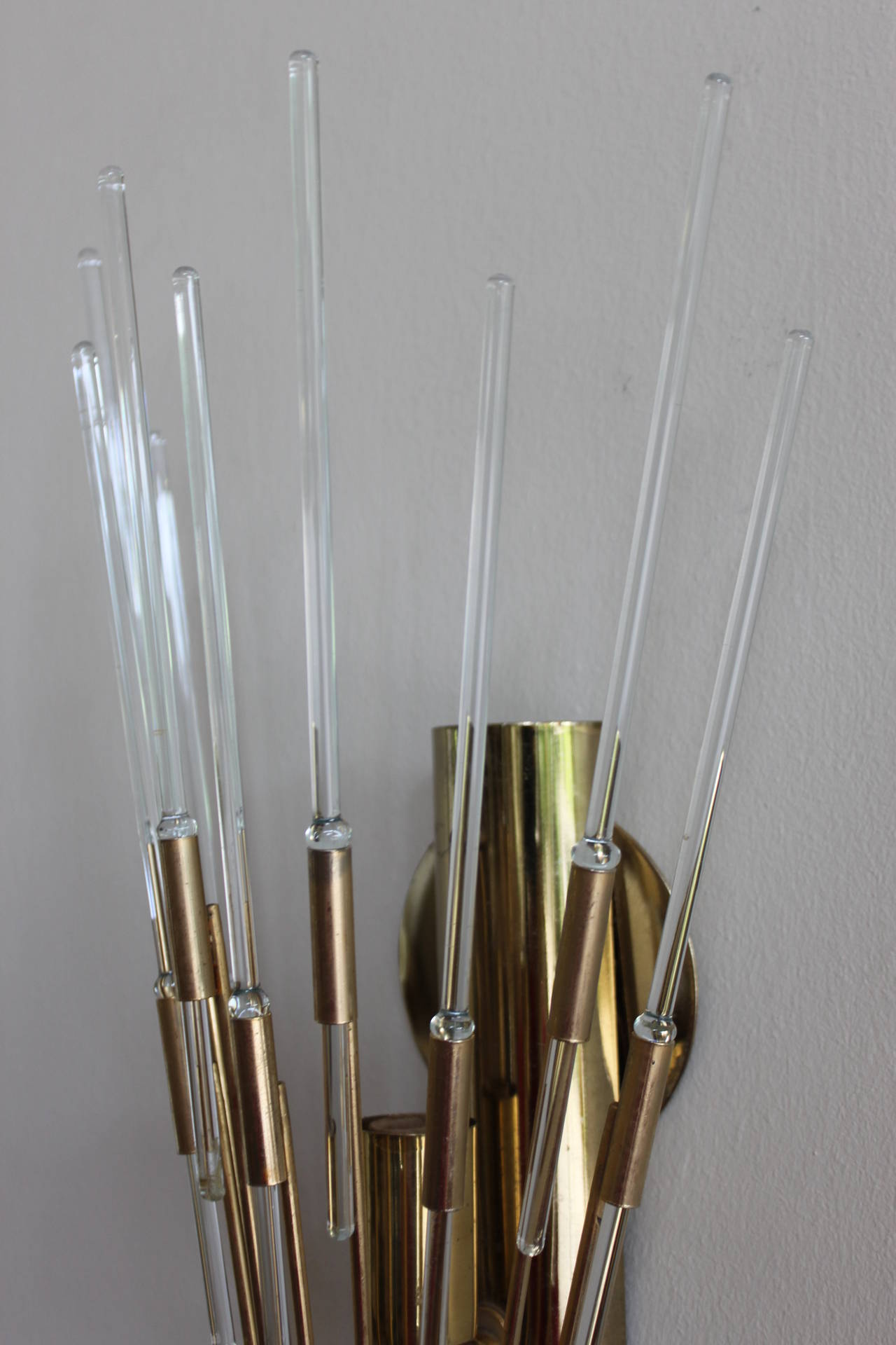Mid 20th century Italian wall sconce in brass with glass rods.   The fixture holds a single small bulb.