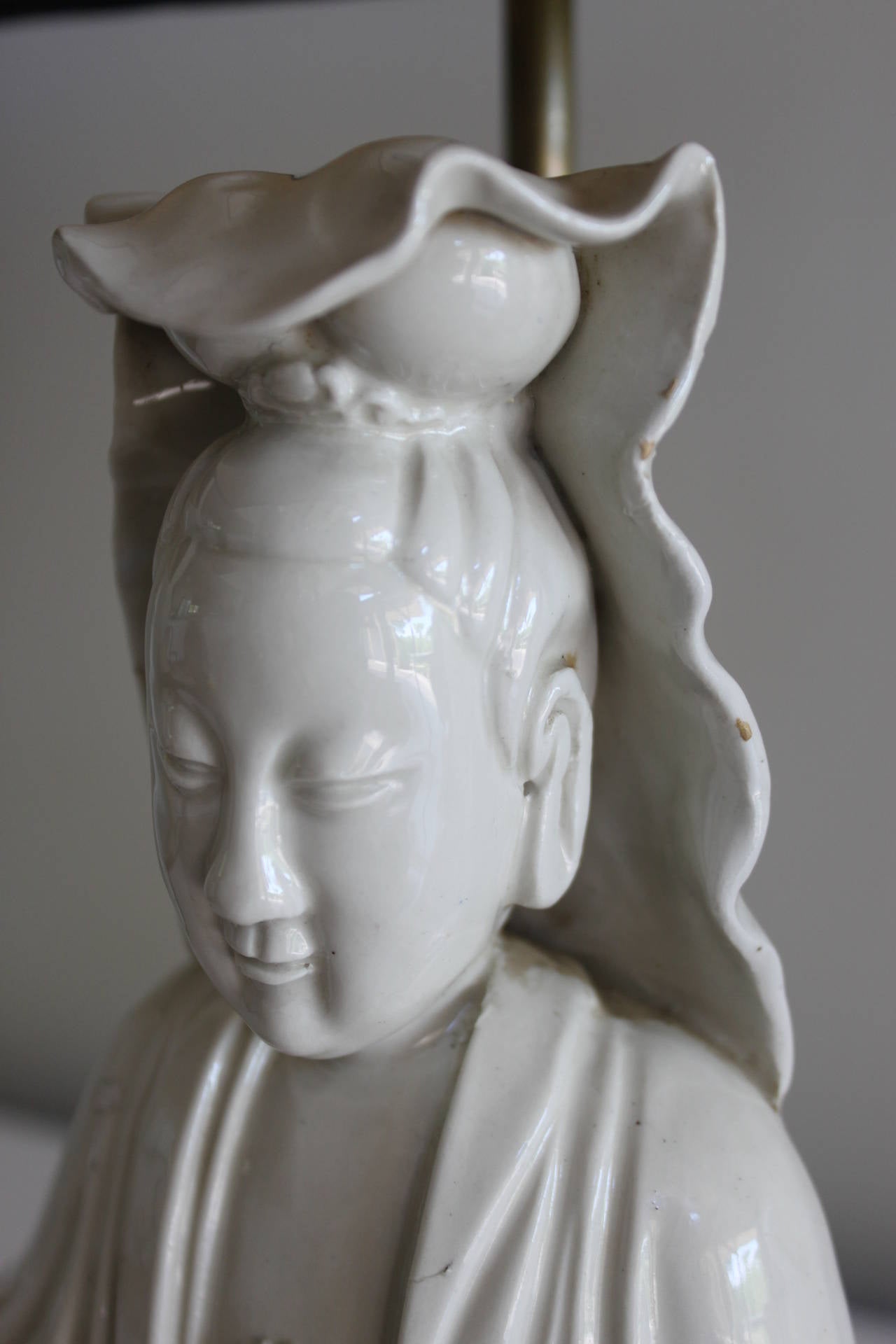 Blanc de Chine seated Kwan Yin or Buddha lamp on a vintage brass base. The figures are 19th century and were wired as lamps in the early 20th century. The figurine has not been drilled and is pushed porcelain. 
One lamp available


Lamps measure