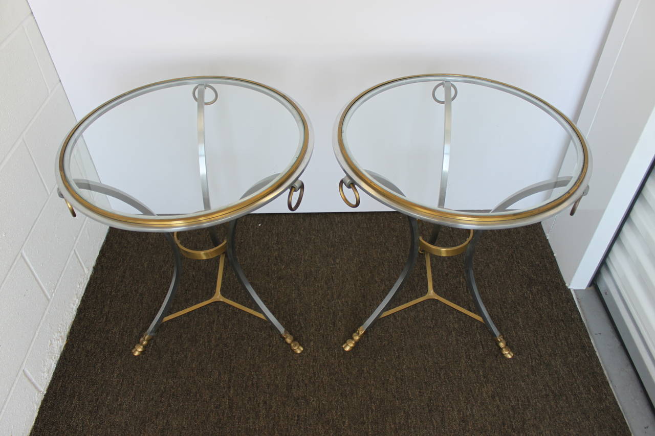 Wonderful pair of steel and bronze gueridon side tables in the style of Maison Jansen. These tables feature bronze hoof feet as well as inset glass tops, France, 1970s.