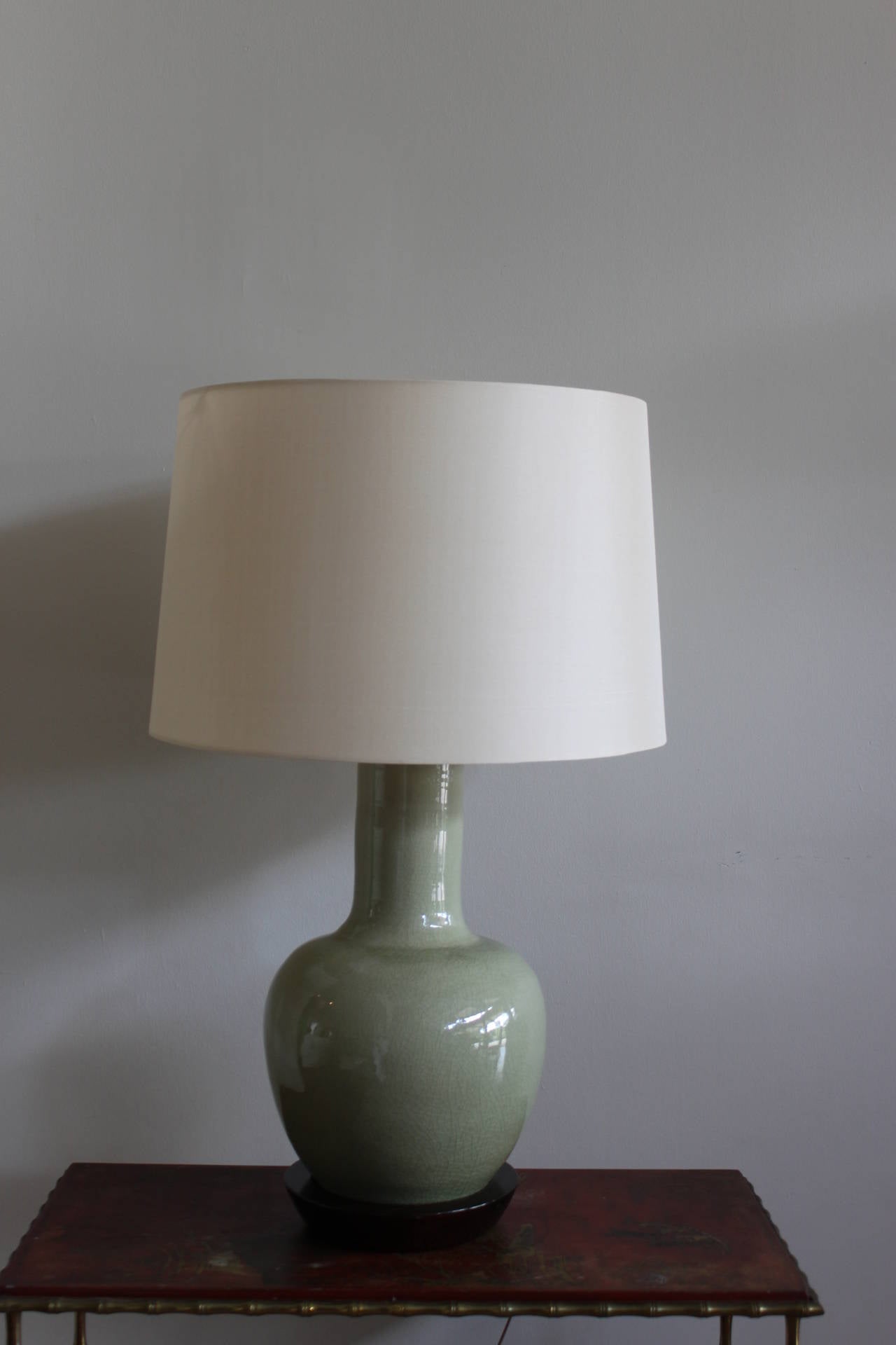 Striking midcentury modern gourd form celadon or pale green lamp with a crackle glaze and original harp and finial.  The lamp is large and beautifully proportioned with a vintage wood base.  Includes a new modern silk shade.