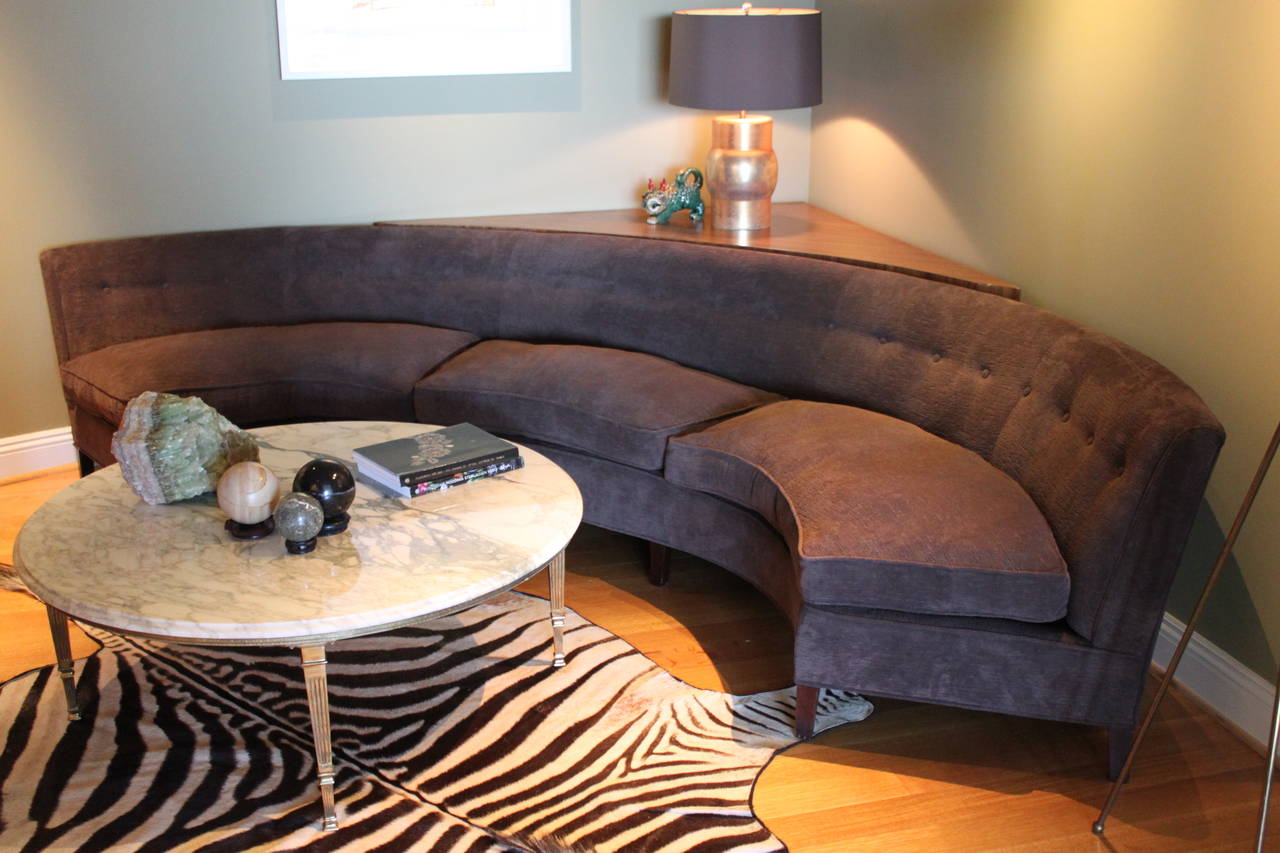 Large curved back sofa in the manner of Harvey Probber with triangle shaped sofa table.  Newly upholstered.