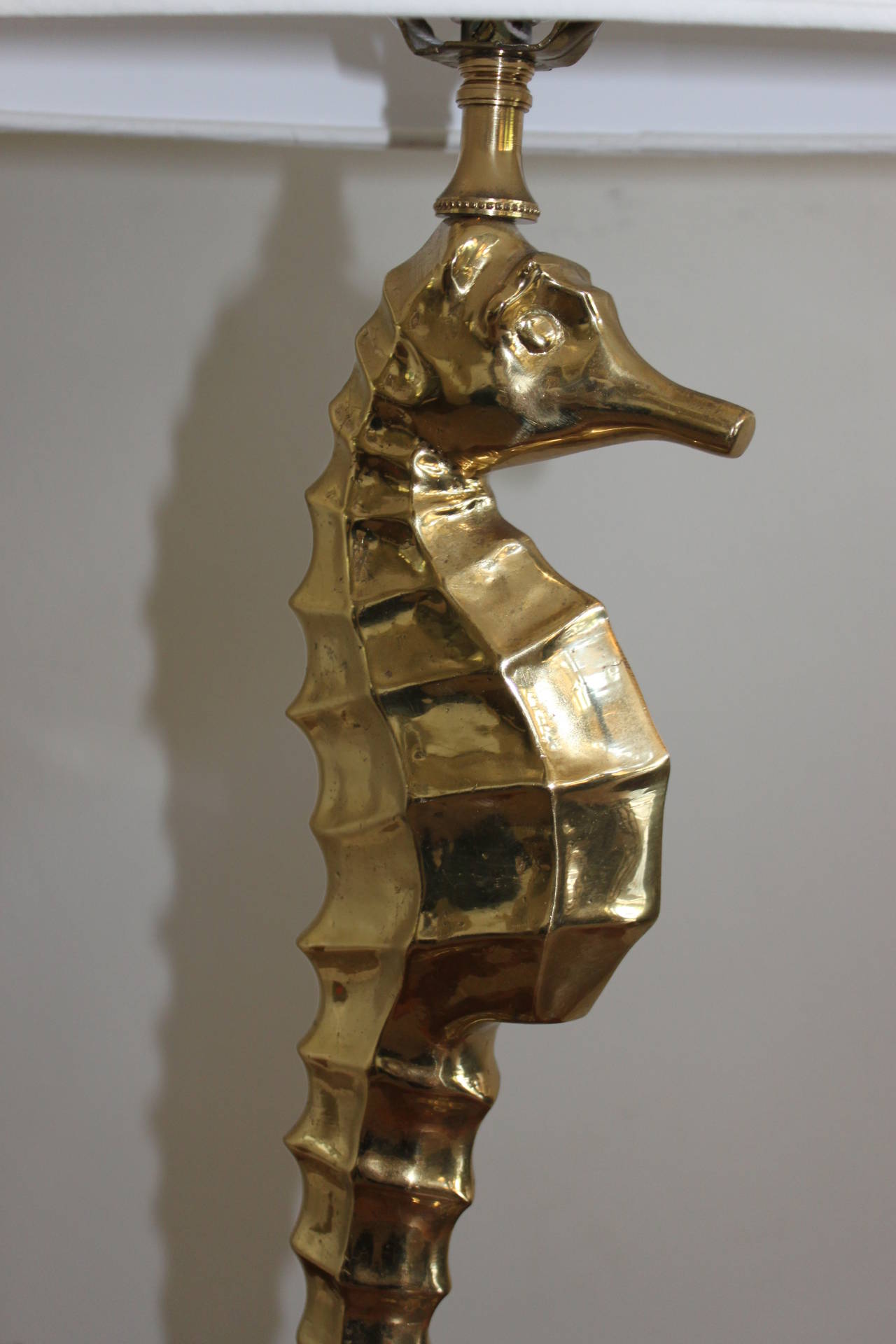 Whimsical brass seahorse lamp on Lucite base. 
Lamp is newly wired with a contemporary linen shade and mounted on a Lucite base.

Shade measures:
15.25