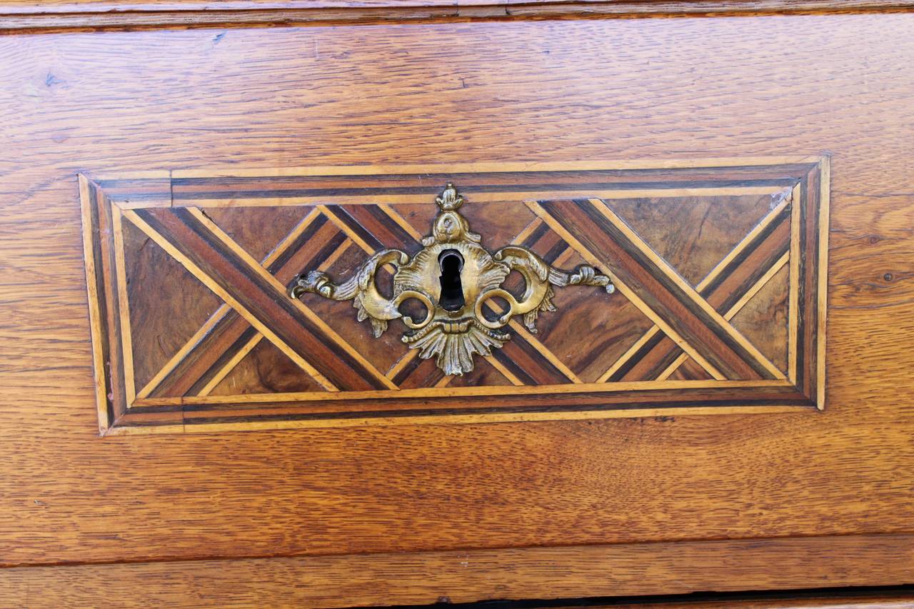 Wonderful Italian fruitwood commode or dresser with inlaid parquetry detailing.  The commode has three drawers with wonderful brasses.  The top drawer contains one compartmentalized drawer with a hidden drawer.  The commode has a beautiful warm