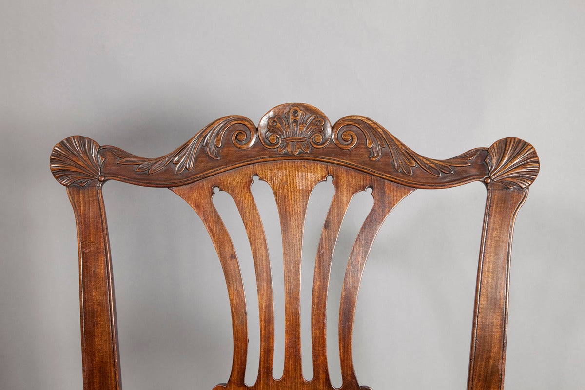 A fine pair of 18th century Irish mahogany side chairs, the acanthus carved backs with scallop shell carving, above a central splat, drop in seats with a wavered frieze carved with a shell, resting on cabriole legs and ball and claw feet.

Irish,