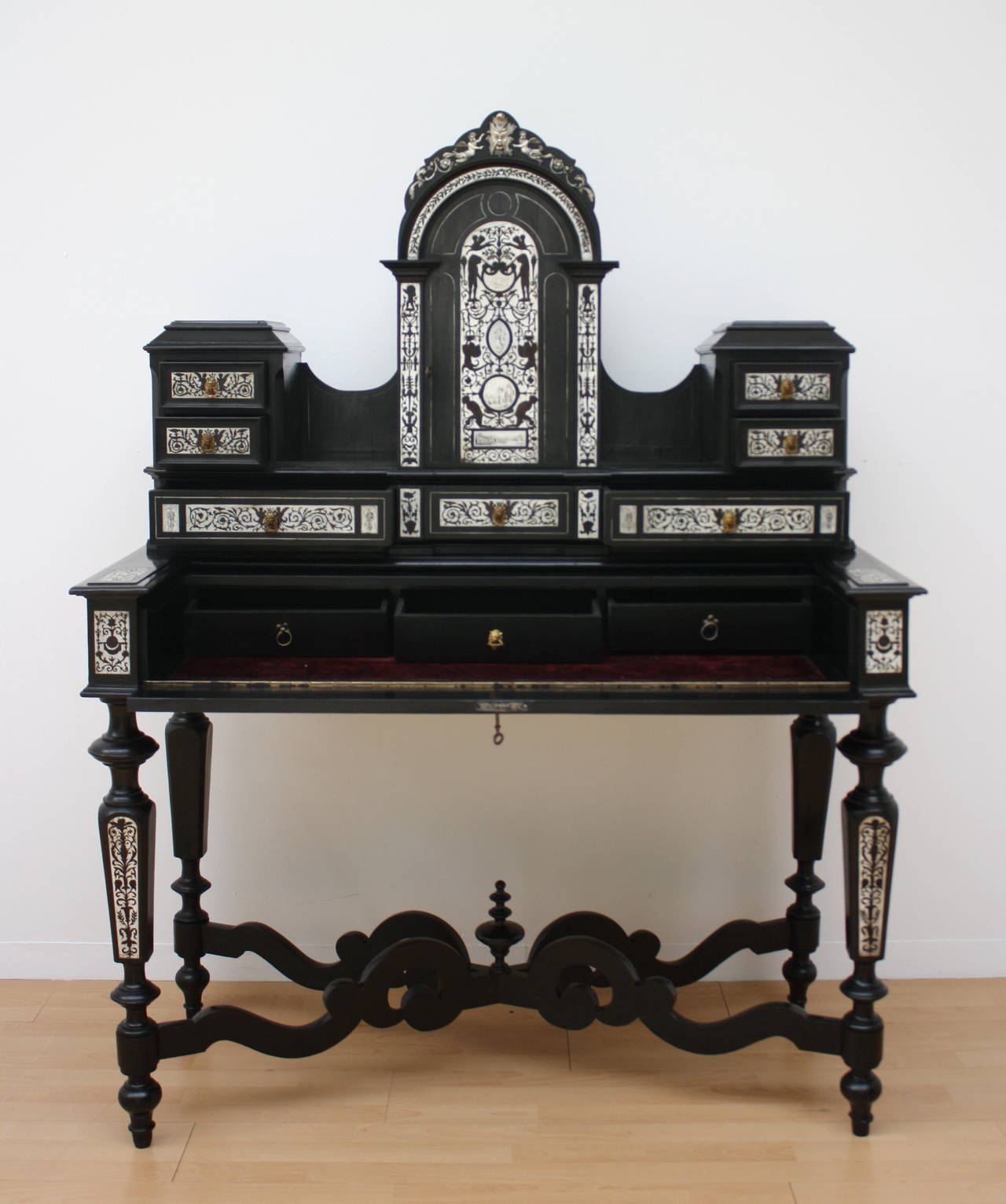 A elegant writing cabinet, ebony Wood all-over with bone inlays, the tabletop with hinged draw, retractable top Panel.