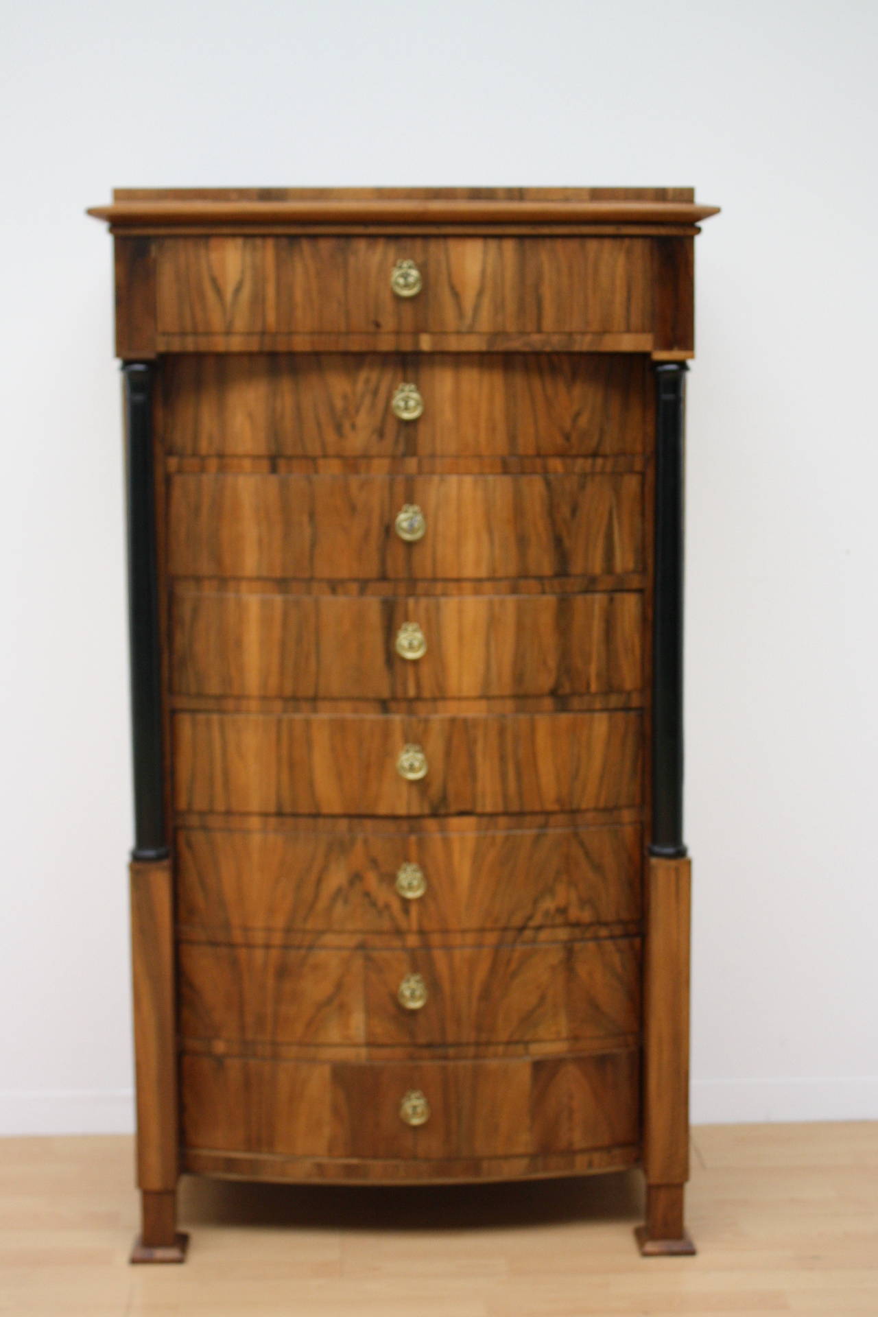 Biedermeier tall eight-drawer chest. Semainier, flanking black columns.