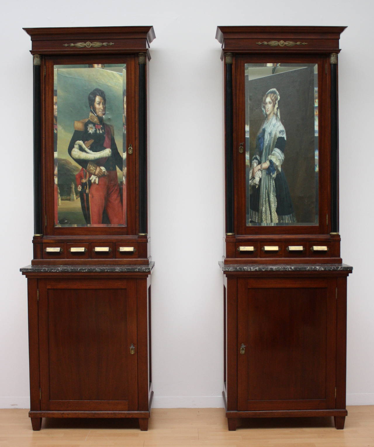 An rare pair of apothecary cabinets, one cupboard with 24 drawer, one with shelves, marble top, four drawer and mirrored tower box, flanked with black columns.