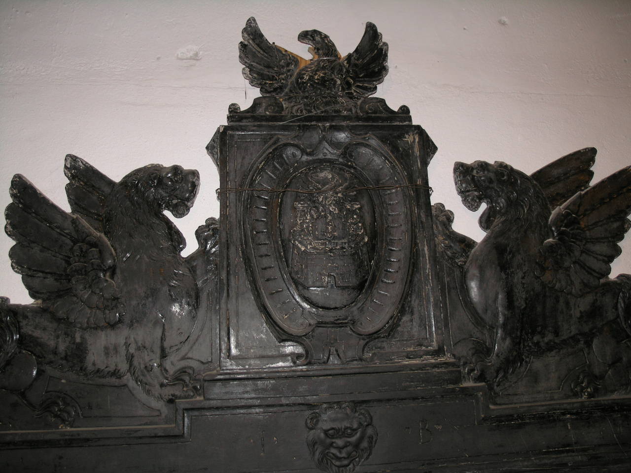 Antique Fireplace Made of Ardesia
Comes from the house of the prince of Rapallo, IT
Rare Renaissance fireplace in richly carved slate; in the center the emblem with the insignia of the family supported by a pair of griffins and surmounted by an